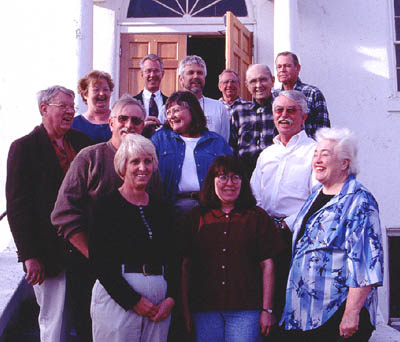 Members of the Grafton Heritage Partnership Project enjoy a laugh before their monthly coordinating meeting at the Community Center in Rockville, UT. Front row (l - r) Shirley Ballard, GHPP Trustee and Grafton land owner. Therese Feinauer, GHPP Trustee and Treasurer Connie Terry, Rockville Historic Preservation Commission member Second row (l - r) Doug Alder, GHPP Trustee and Fundraising Committee Chairperson Jeff Ballard, Grafton land owner Anne Stanworth, Bureau of Land Management representative Don Falvey, Zion National Park Superintendant Back row (l - r) Arlene Ward, descendant of Grafton pioneer Alonzo H. Russell Jim Coleman, GHPP Trustee, Alonzo Russell descendant Jim McMahon, Virgin River Program Director, Grand Canyon Trust Calvin Johnson, GHPP Trustee, runs cattle in and near Grafton LuWayne Wood, GHPP Trustee, born in Grafton David Hatfield, GHPP Trustee and Chair, Mayor of Rockville